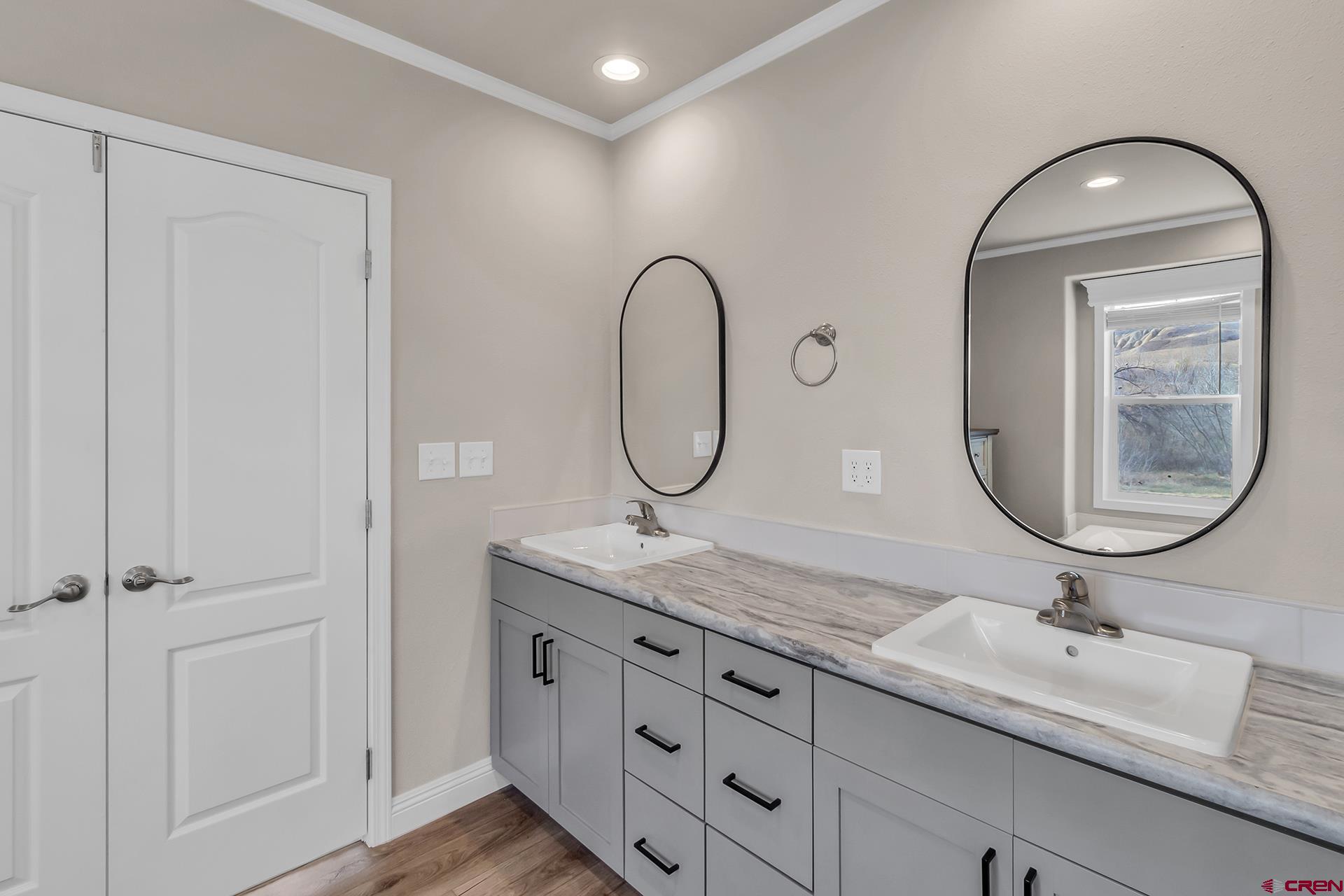 21357 Knight Road Austin, CO 81410 - Photo 18 of 35 a bathroom with a granite countertop double vanity sinks and a mirror