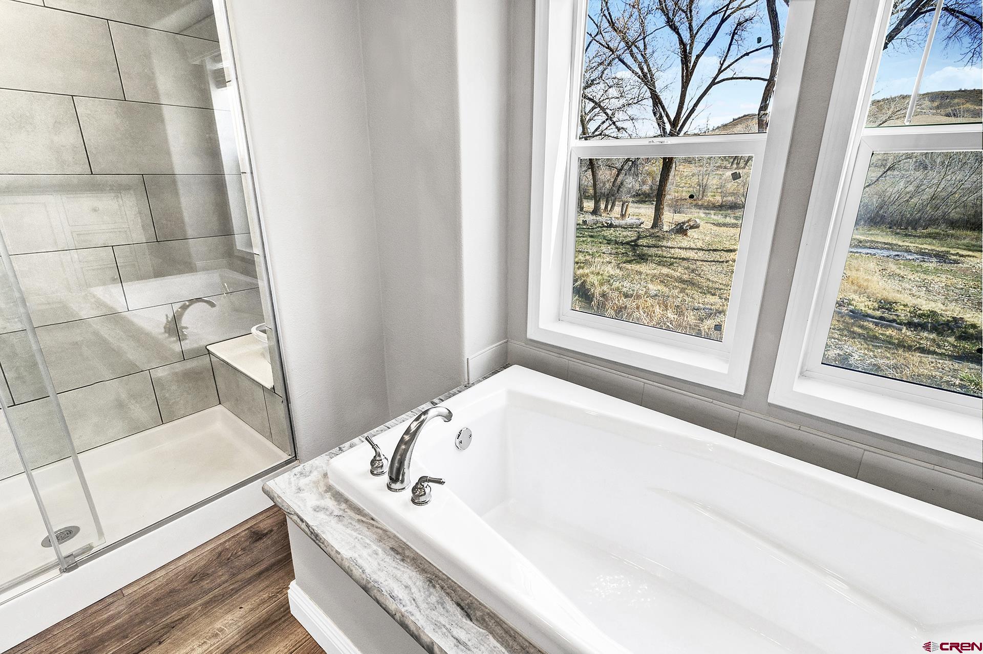 21357 Knight Road Austin, CO 81410 - Photo 19 of 35 a bath tub sitting next to a window