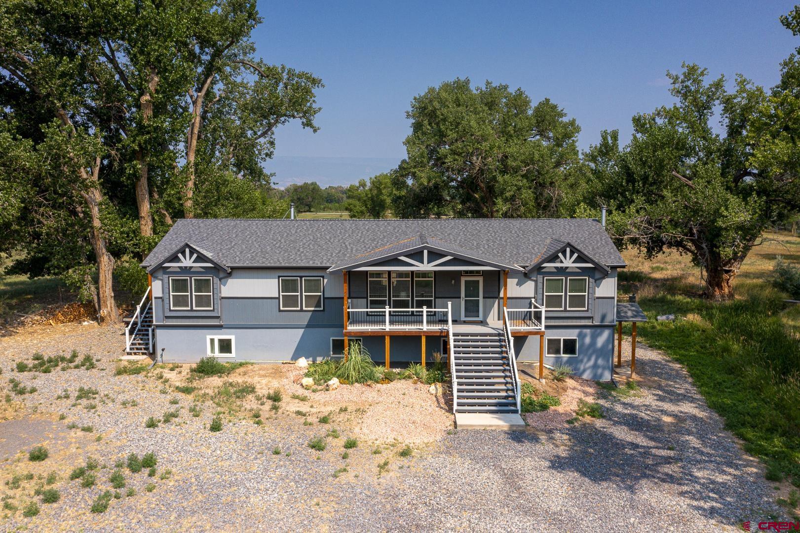 21357 Knight Road Austin, CO 81410 - Photo 2 of 35 front view of a house with a yard