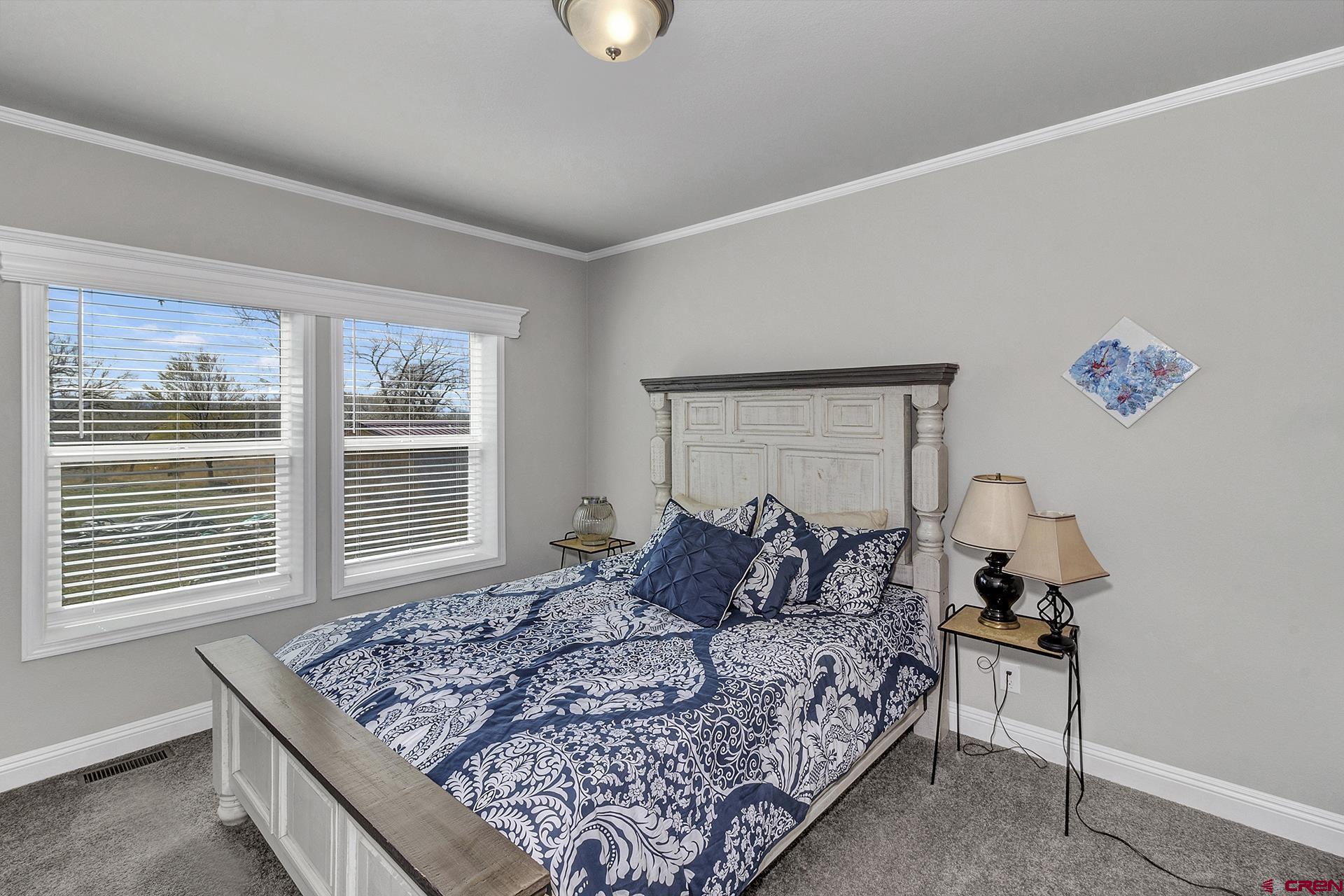 21357 Knight Road Austin, CO 81410 - Photo 23 of 35 a bed sitting in a bedroom next to a window