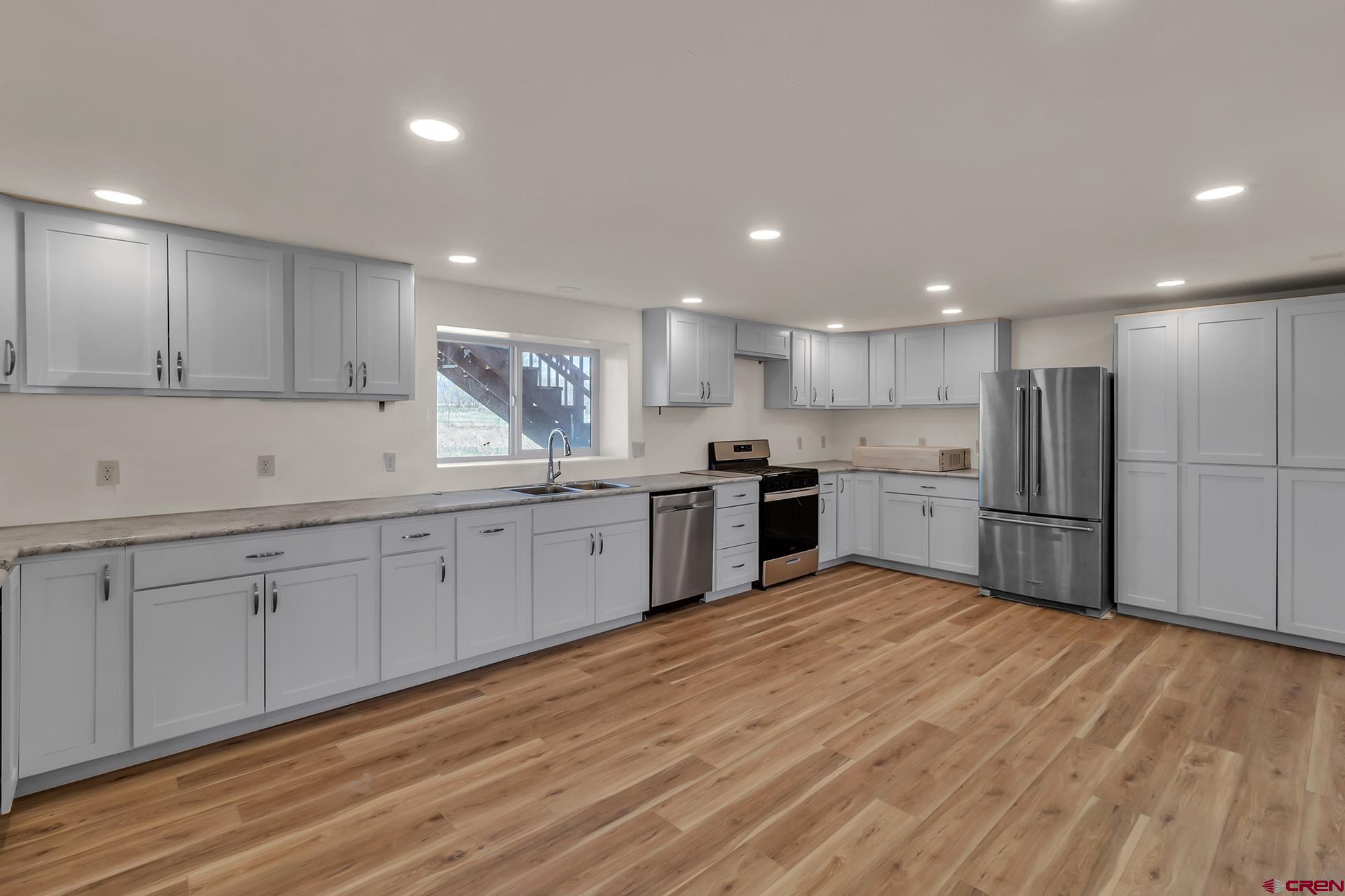 21357 Knight Road Austin, CO 81410 - Photo 27 of 35 a kitchen with stainless steel appliances granite countertop a stove sink and cabinets