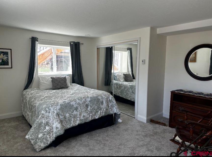 21357 Knight Road Austin, CO 81410 - Photo 29 of 35 a bedroom with a bed and a mirror
