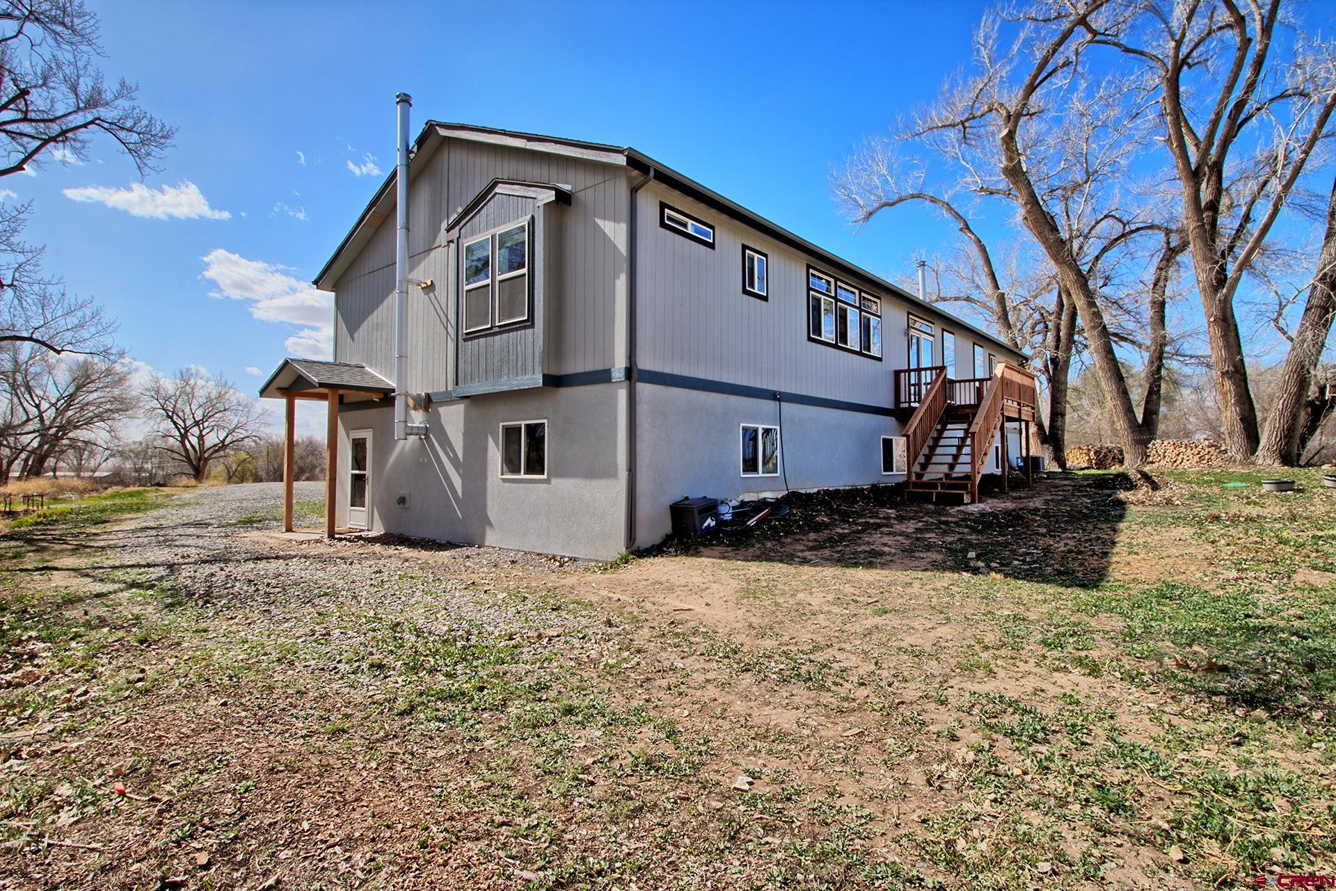 21357 Knight Road Austin, CO 81410 - Photo 6 of 35 a front view of a house with a yard