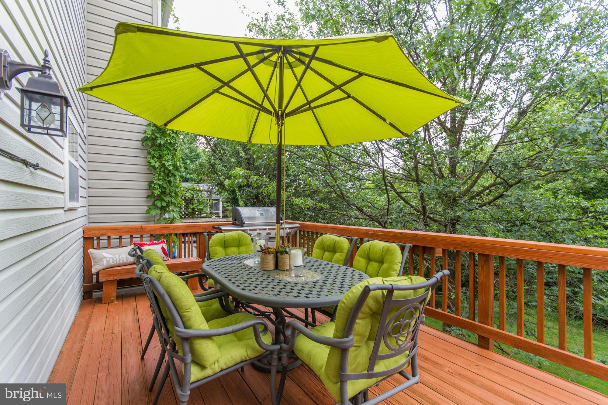 6162 Good Hunters Ride Columbia, MD 21045 - Photo 26 of 30 a patio of a house with table and chairs under an umbrella