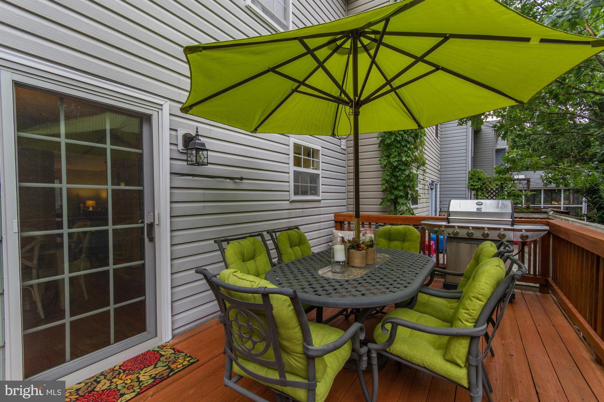 6162 Good Hunters Ride Columbia, MD 21045 - Photo 27 of 30 a view of an outdoor sitting area with furniture and umbrella
