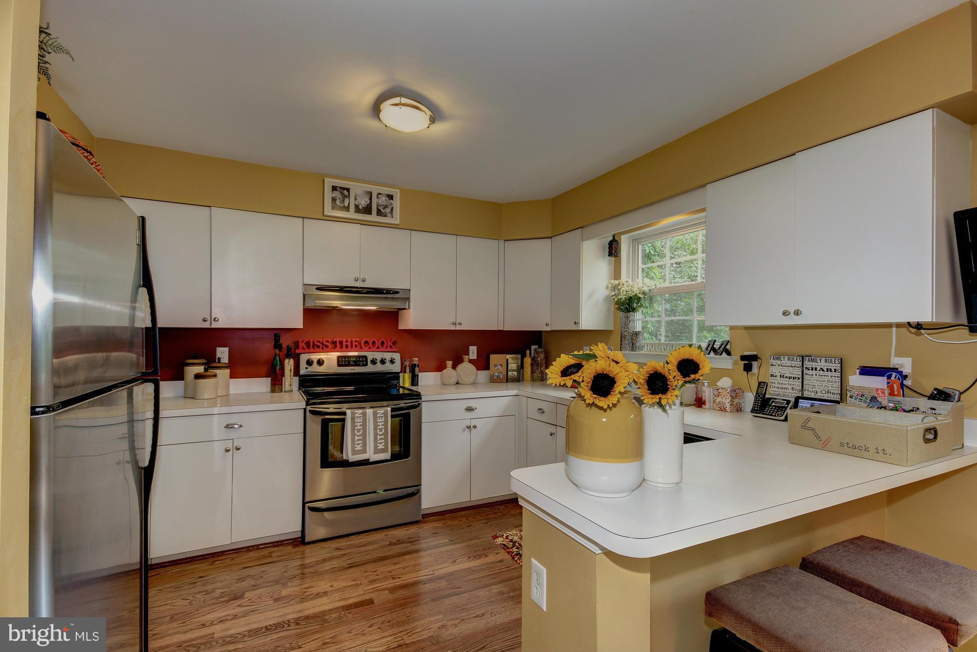 6162 Good Hunters Ride Columbia, MD 21045 - Photo 8 of 30 a kitchen with a sink a stove and cabinets