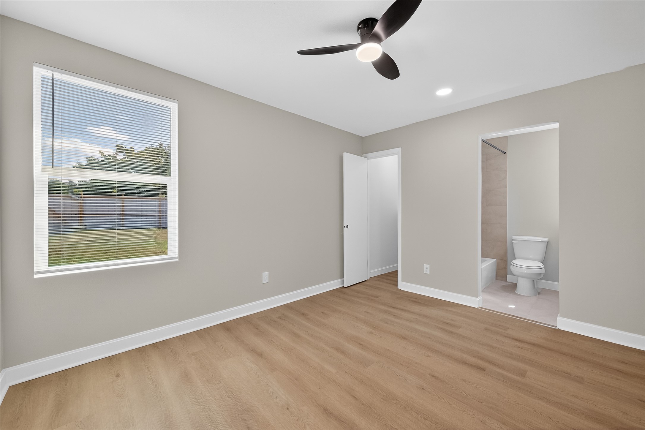 889 Chas Lane Houston, TX 77091 - Photo 23 of 32 a view of an empty room with a window and wooden floor