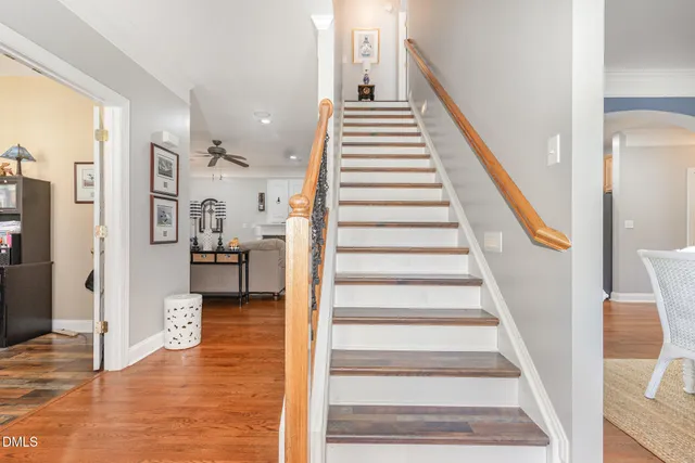a dining room with furniture a chandelier and wooden floor