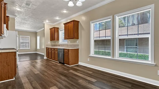 a view of kitchen with cabinets and wooden floor