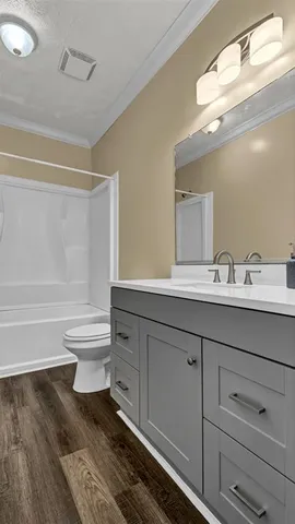 a bathroom with a toilet a sink and mirror