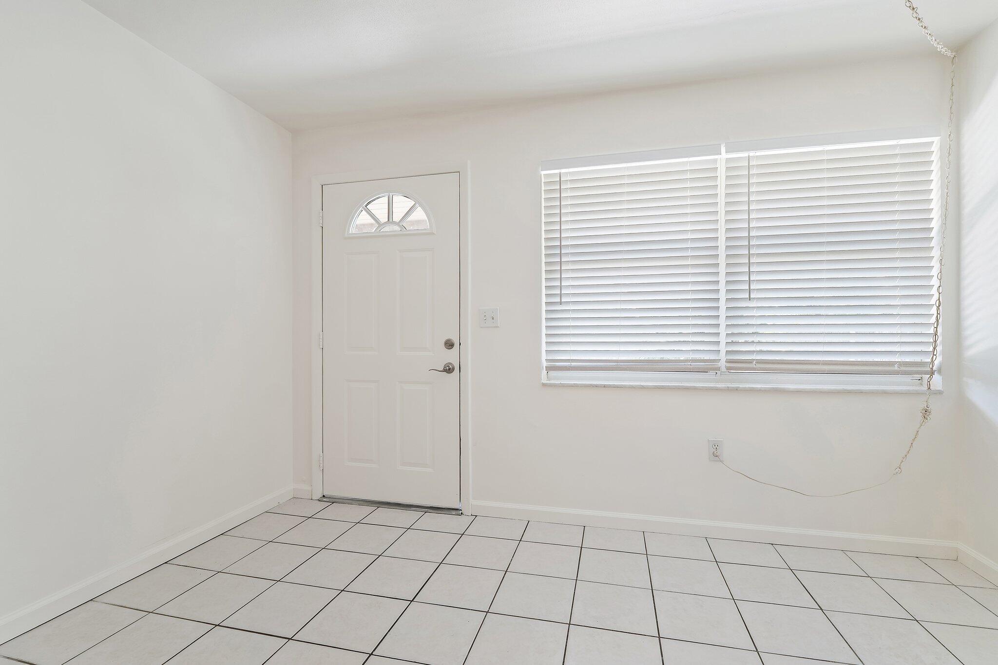 19147 Southeast Hillcrest Drive, Unit A Jupiter, FL 33469 - Photo 2 of 17 a view of an empty room with window