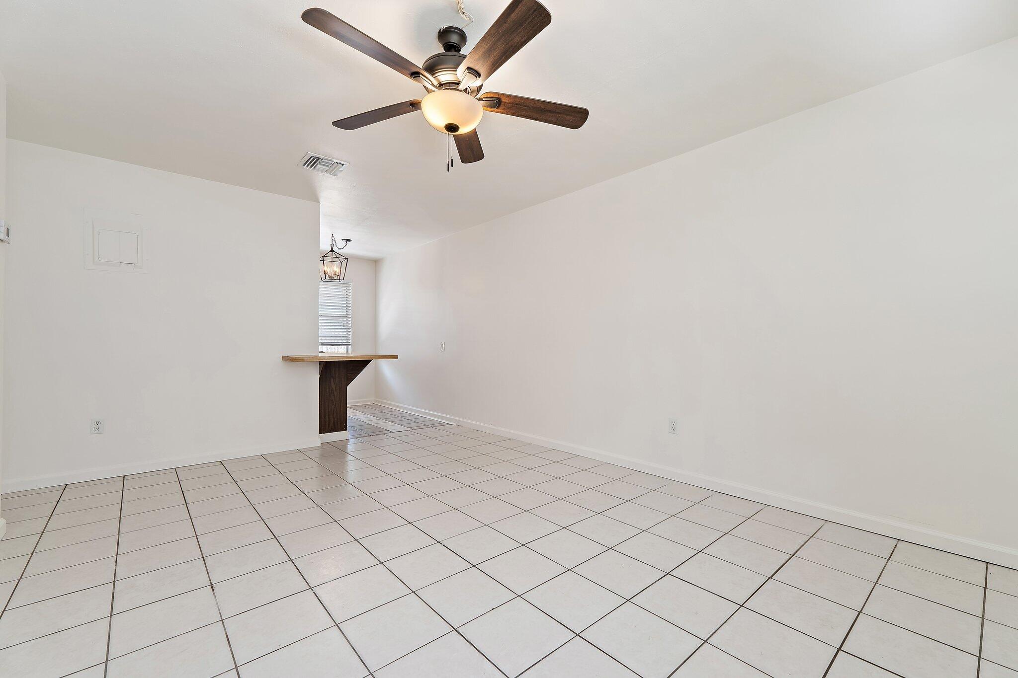 19147 Southeast Hillcrest Drive, Unit A Jupiter, FL 33469 - Photo 3 of 17 wooden floor in an empty room