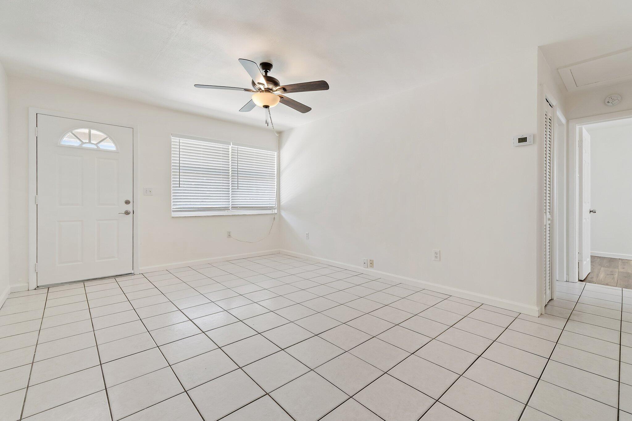 19147 Southeast Hillcrest Drive, Unit A Jupiter, FL 33469 - Photo 5 of 17 a view of an empty room and window
