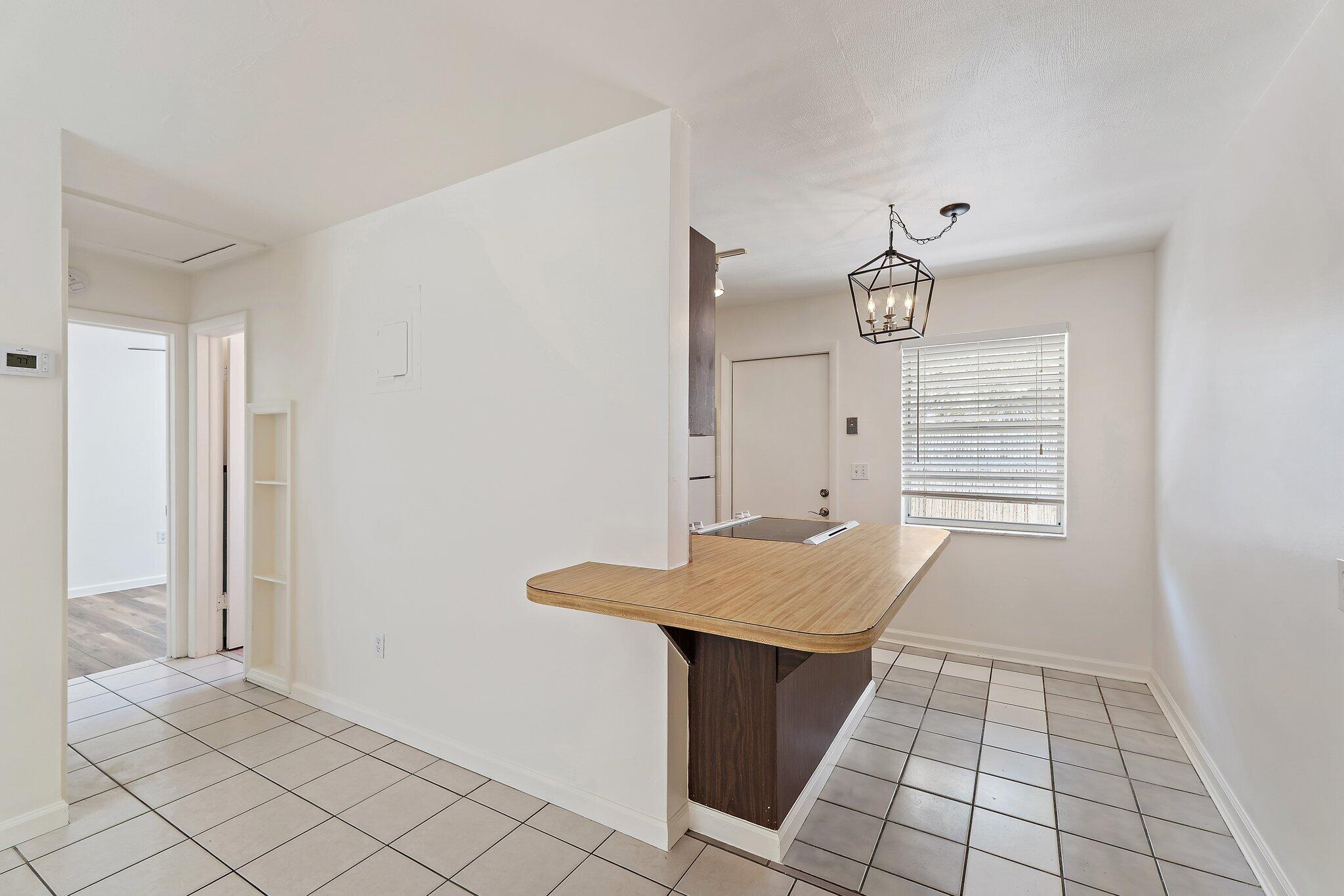 19147 Southeast Hillcrest Drive, Unit A Jupiter, FL 33469 - Photo 7 of 17 a view of a kitchen with granite countertop and white cabinets