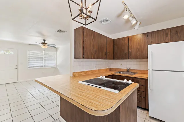 a kitchen with a appliances a sink and cabinets