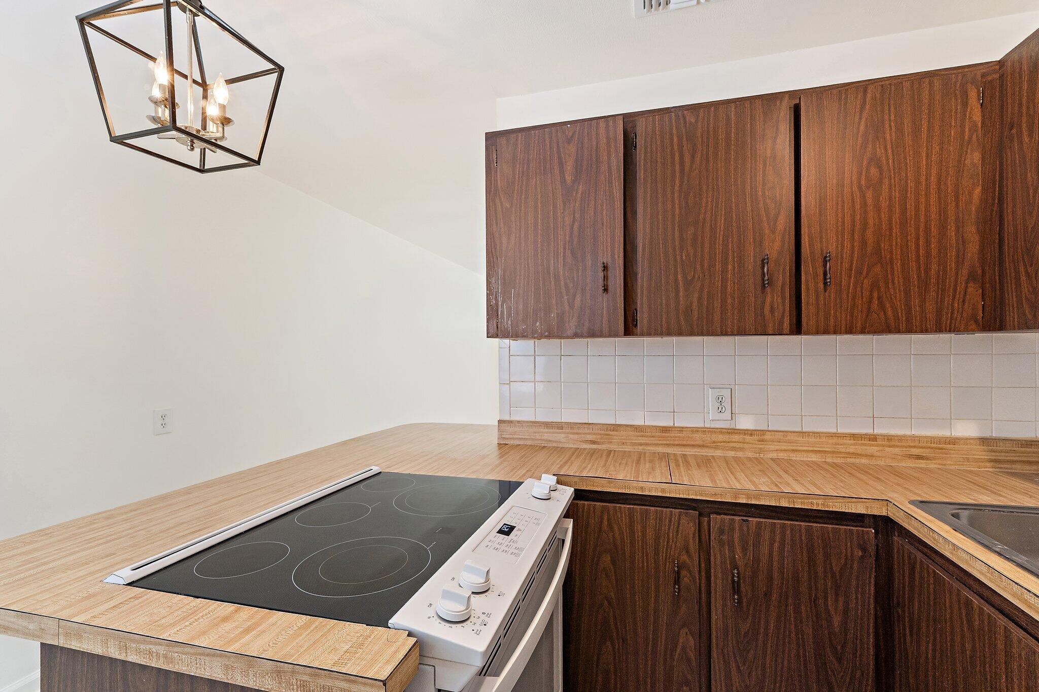 19147 Southeast Hillcrest Drive, Unit A Jupiter, FL 33469 - Photo 9 of 17 a view of a kitchen with wooden floor