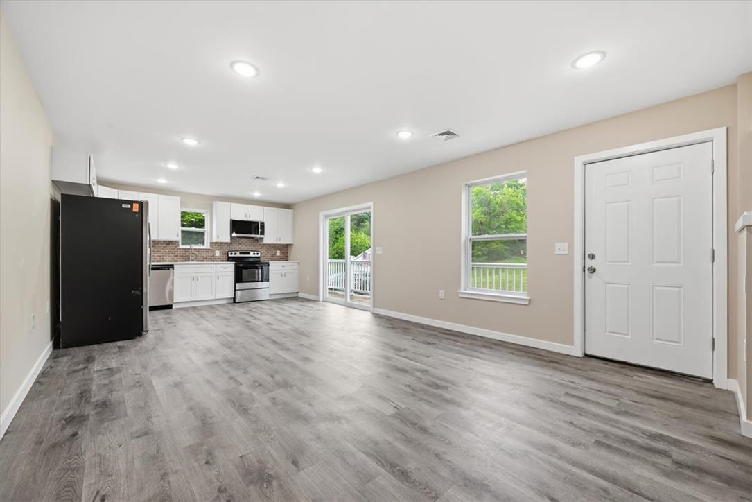 5641 North Coplay Road Whitehall, PA 18052 - Photo 11 of 68 A new construction kitchen features stainless steel appliances and abundant natural light from large windows and a glass sliding door.