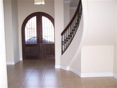 16259 Summit Ranch Road Clovis, CA 93619 - Photo 5 of 18 foyer with imported arched wood door, the grand staircase with iron stair well