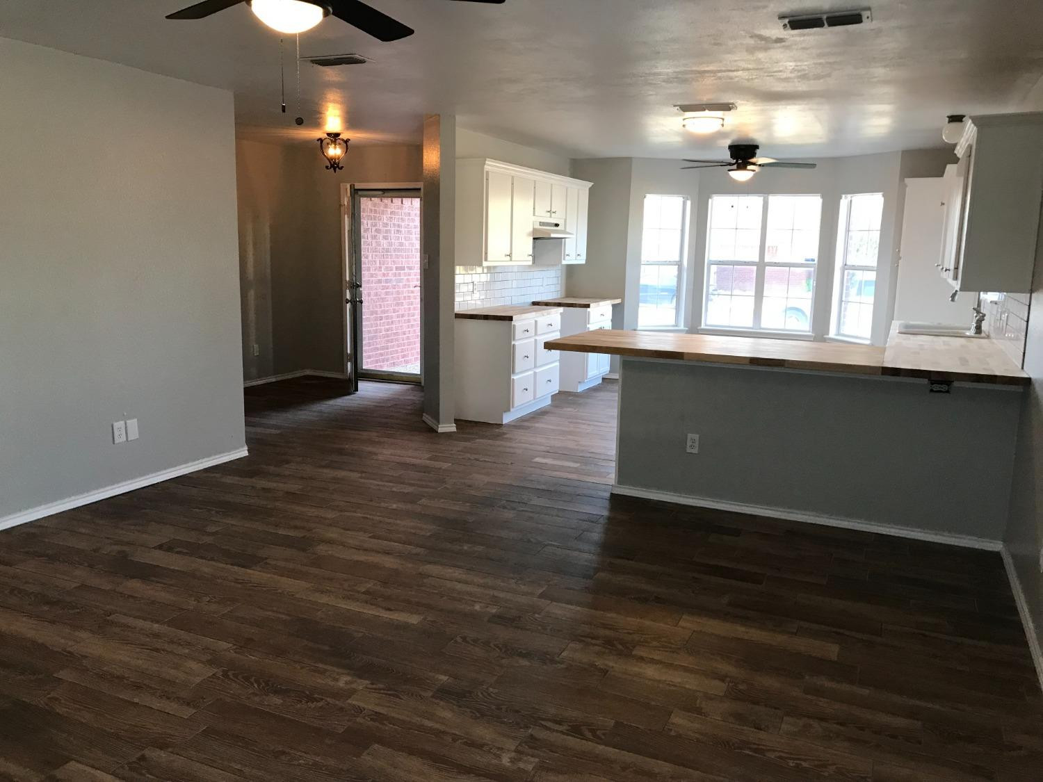 6201 5th Street Lubbock, TX 79416 - Photo 11 of 32 an open kitchen with a sink and dish washer