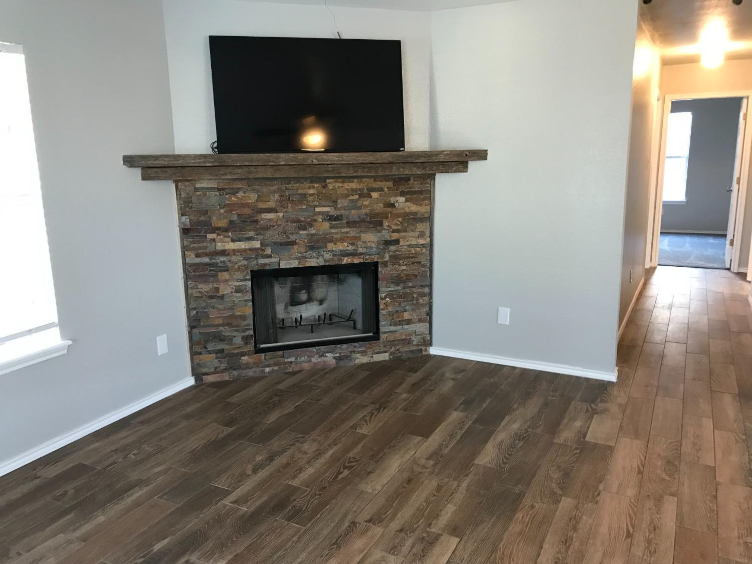 6201 5th Street Lubbock, TX 79416 - Photo 14 of 32 a living room with a fireplace