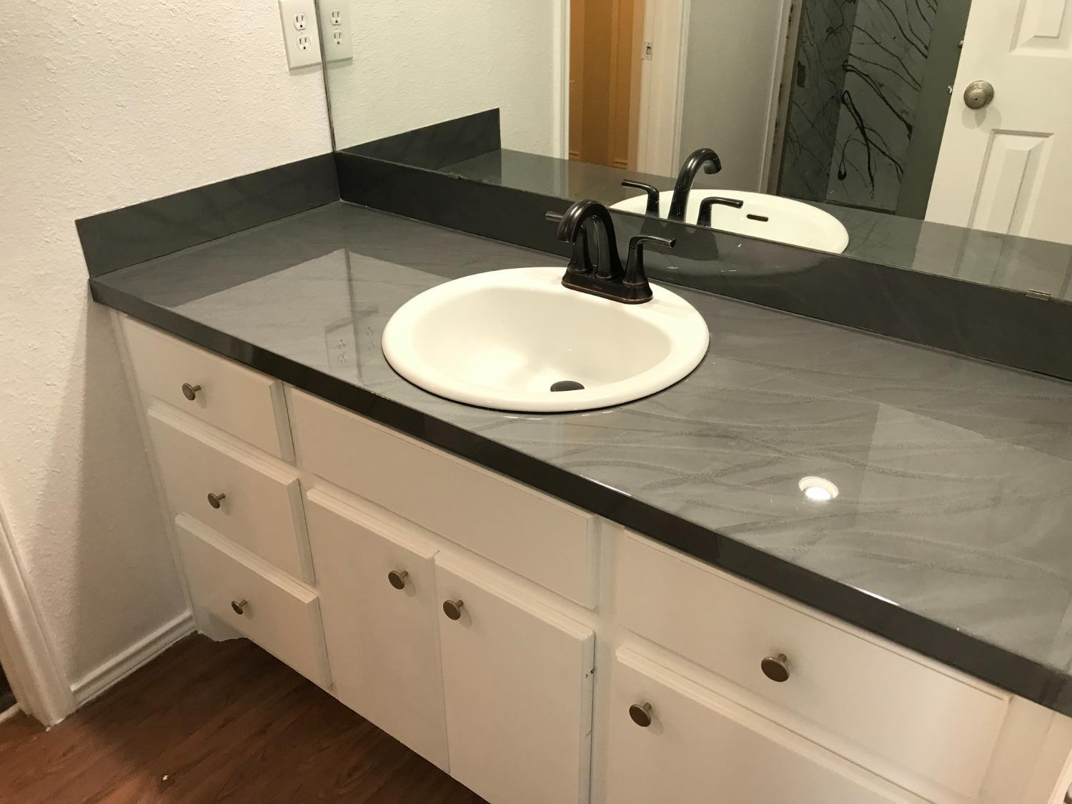 6201 5th Street Lubbock, TX 79416 - Photo 21 of 32 a bathroom with a sink and a mirror