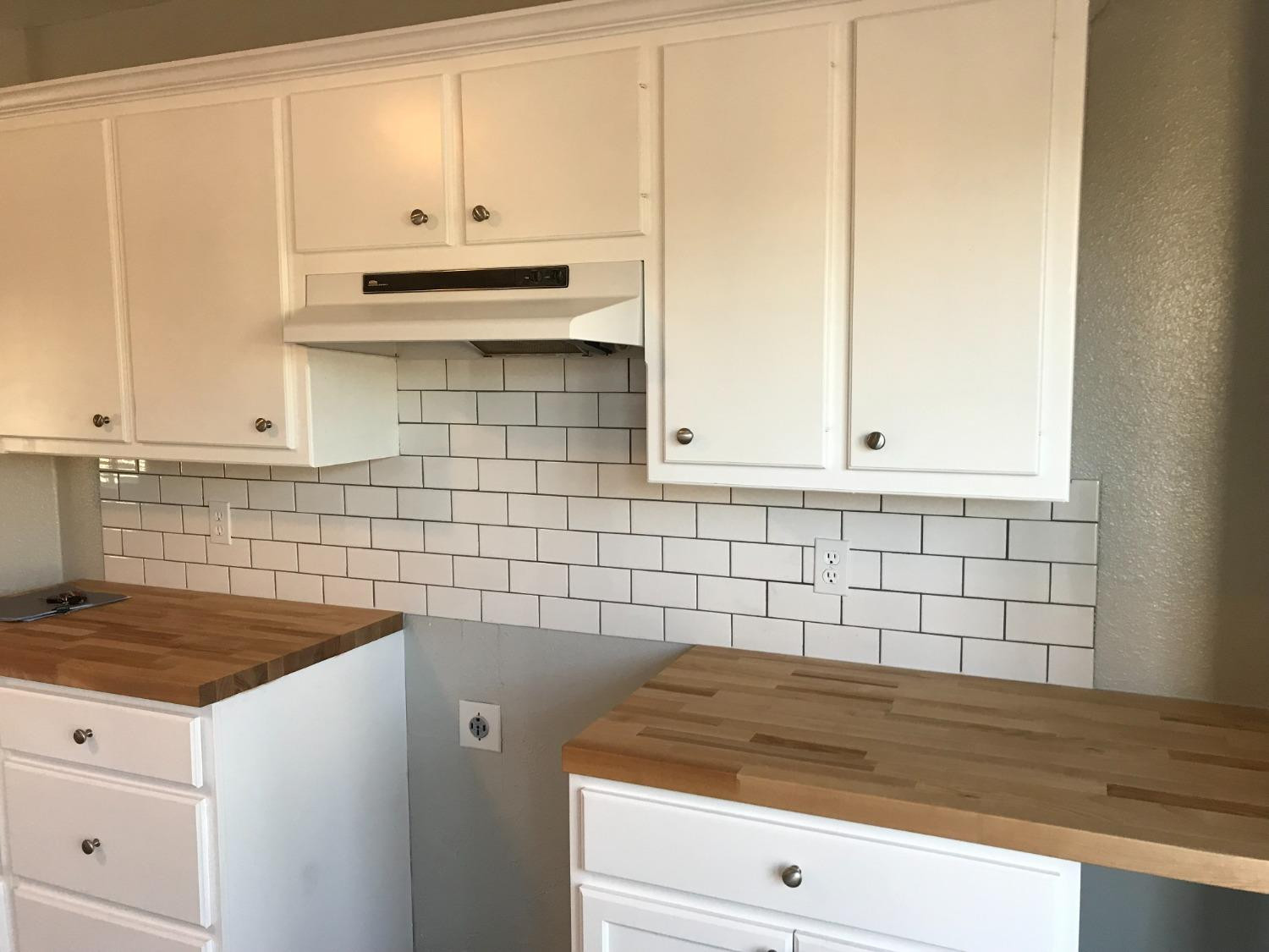 6201 5th Street Lubbock, TX 79416 - Photo 7 of 32 a kitchen with granite countertop white cabinets and a stove