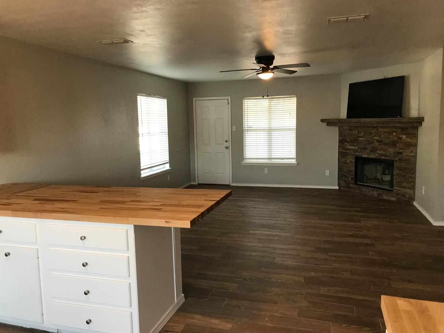6201 5th Street Lubbock, TX 79416 - Photo 10 of 32 wooden floor in an empty room with a window