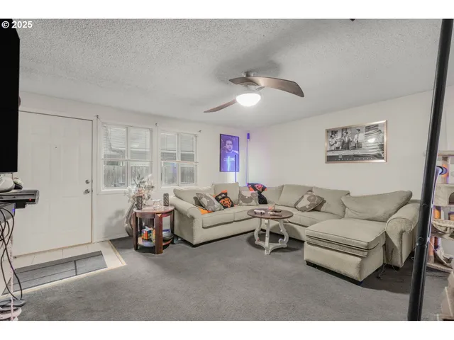 a living room with furniture chess board and a window