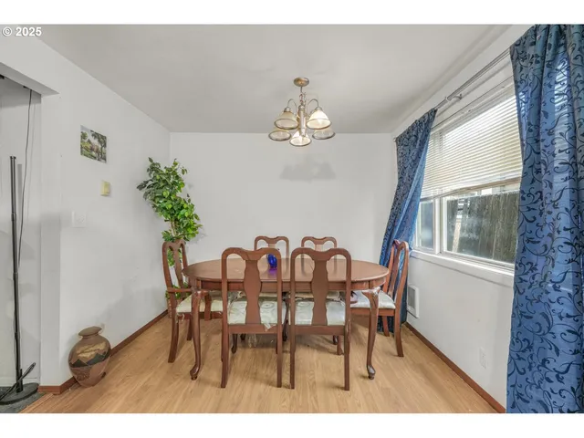 a view of a dining room with furniture and chandelier