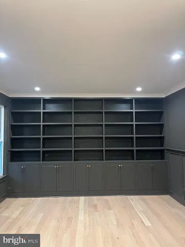 a view of empty room with wooden floor and fireplace