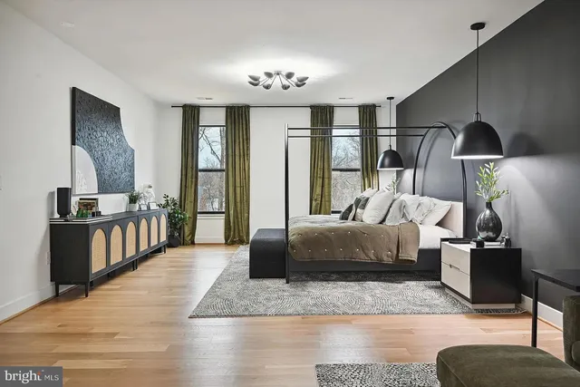 a open kitchen with kitchen island a stove a sink and a wooden floors