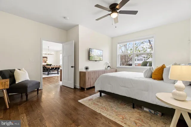 a spacious bedroom with a bed and ceiling fan