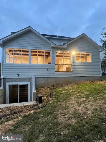 a house view with a sitting space and garden
