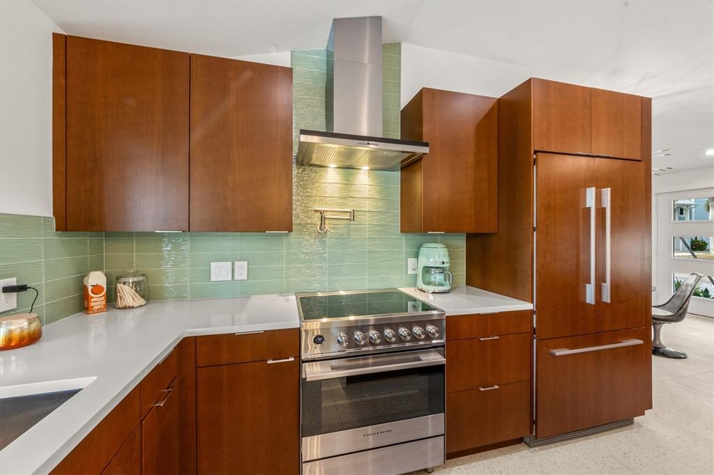 505 65th Street Holmes Beach, FL 34217 - Photo 13 of 64 a kitchen with stainless steel appliances granite countertop a sink stove and refrigerator