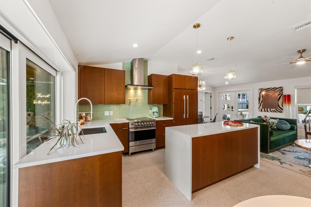 505 65th Street Holmes Beach, FL 34217 - Photo 15 of 64 a living room with stainless steel appliances furniture a rug and a kitchen view