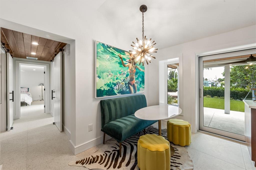 505 65th Street Holmes Beach, FL 34217 - Photo 16 of 64 a view of a dining room with furniture a livingroom and chandelier