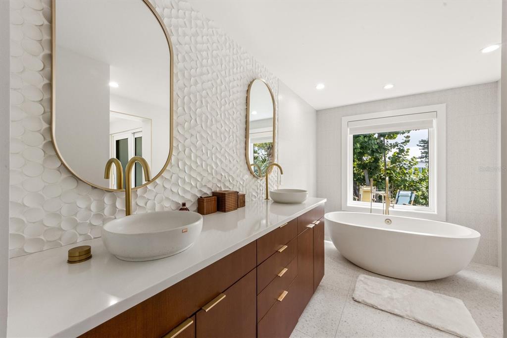 505 65th Street Holmes Beach, FL 34217 - Photo 22 of 64 a view of a bathroom with a sink and mirror