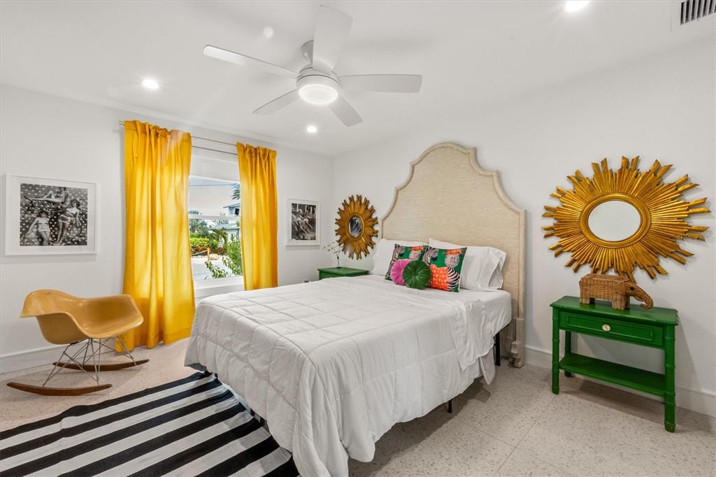 505 65th Street Holmes Beach, FL 34217 - Photo 28 of 64 a bedroom with a bed and dresser