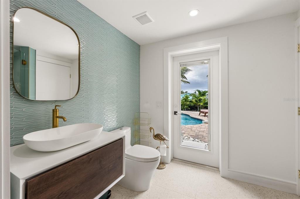 505 65th Street Holmes Beach, FL 34217 - Photo 30 of 64 a bathroom with a sink a toilet and shower