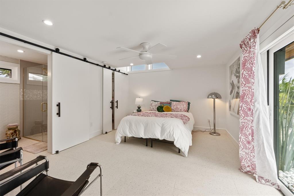 505 65th Street Holmes Beach, FL 34217 - Photo 33 of 64 a bed room with a bed window and a mirror