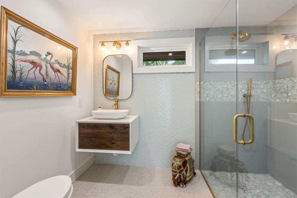 505 65th Street Holmes Beach, FL 34217 - Photo 35 of 64 a bathroom with a sink mirror and toilet