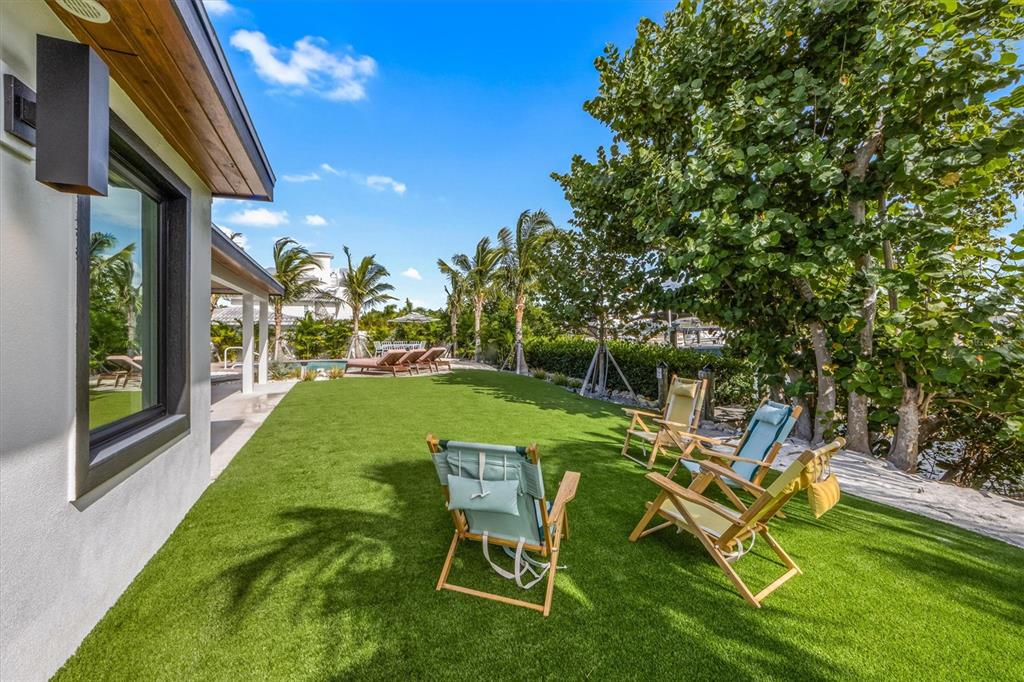 505 65th Street Holmes Beach, FL 34217 - Photo 46 of 64 a view of a chair and table on the patio