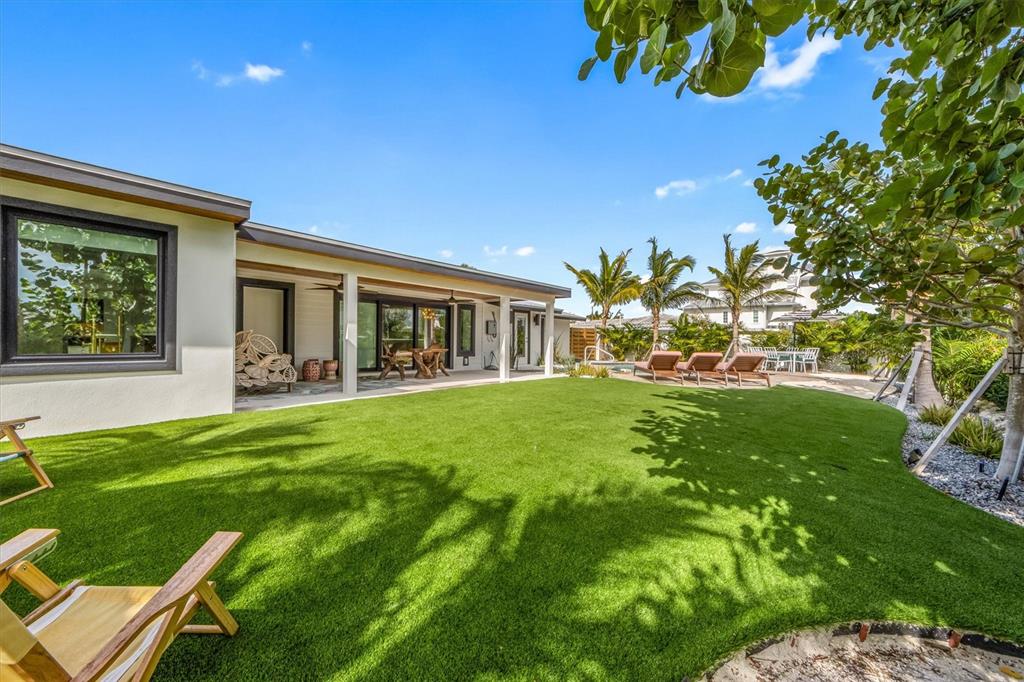 505 65th Street Holmes Beach, FL 34217 - Photo 48 of 64 a view of house with backyard porch and garden