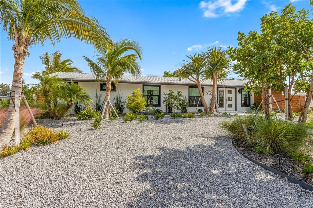505 65th Street Holmes Beach, FL 34217 - Photo 5 of 64 a front view of a house with garden