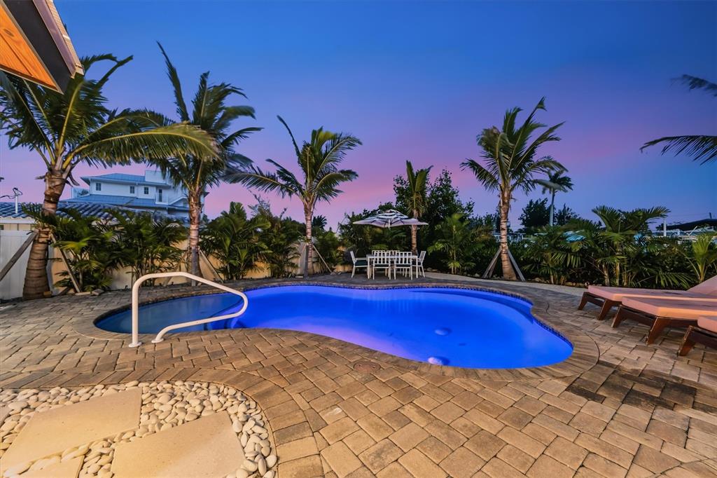 505 65th Street Holmes Beach, FL 34217 - Photo 53 of 64 a view of swimming pool with chairs