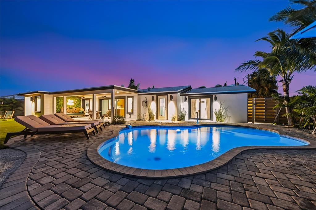 505 65th Street Holmes Beach, FL 34217 - Photo 55 of 64 a view of a swimming pool with sitting area