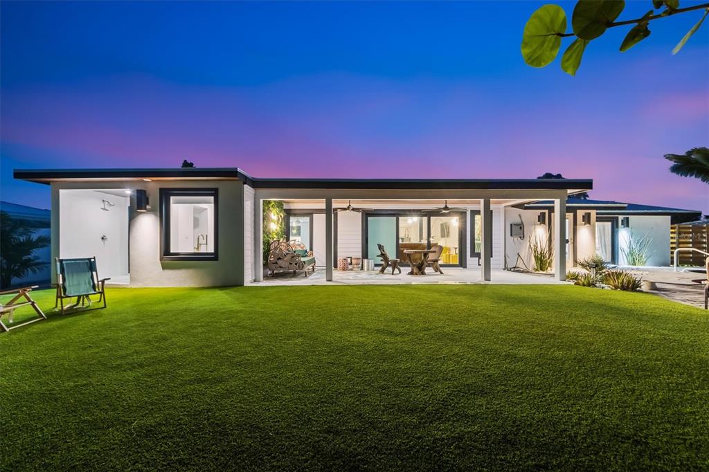 505 65th Street Holmes Beach, FL 34217 - Photo 57 of 64 a front view of a house with a garden