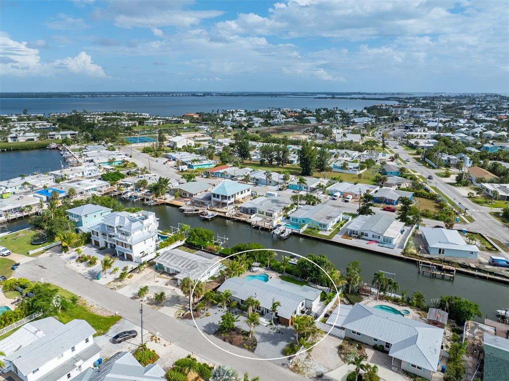 505 65th Street Holmes Beach, FL 34217 - Photo 63 of 64 an aerial view of a city with lots of residential buildings and ocean view in back