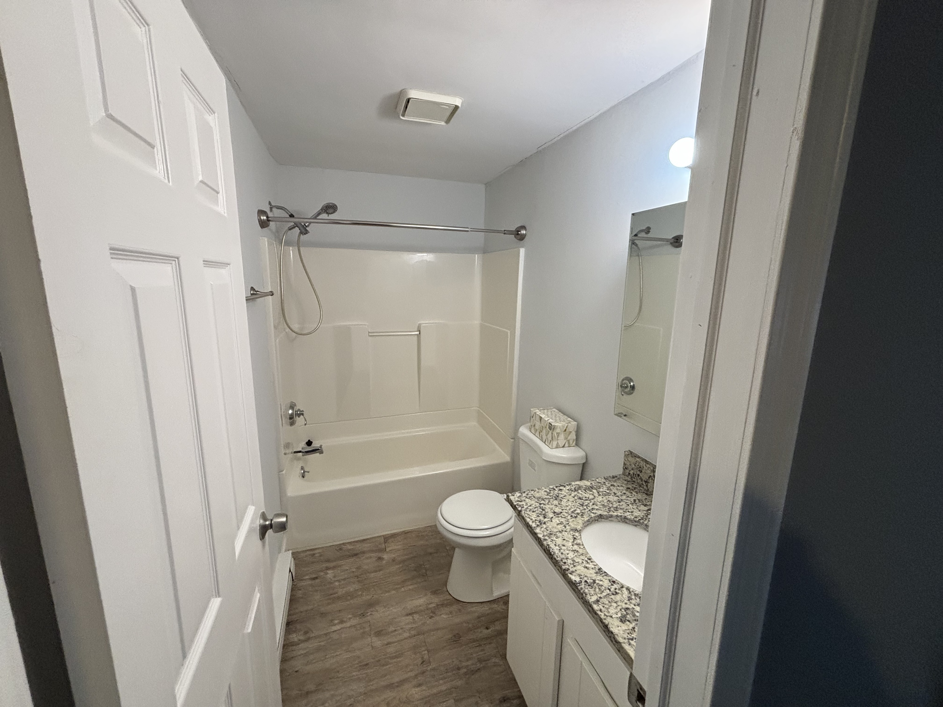 39 Horton Hill Road, Unit 9B Naugatuck, CT 06770 - Photo 5 of 10 a bathroom with a granite countertop white toilet a sink and a shower