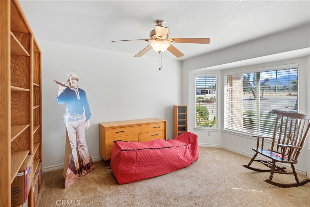 11025 El Esteban Road Phelan, CA 92371 - Photo 26 of 54 a bedroom with a bed and a chandelier